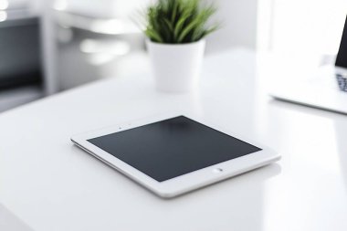 Minimalist Tablet and Stylus on Clean White Desk - Perfect for Graphic Designers clipart