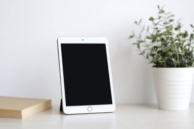 Minimalist Tablet and Stylus on Clean White Desk - Perfect for Graphic Designers