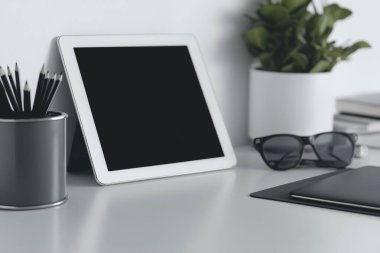 Minimalist Tablet and Stylus on Clean White Desk - Perfect for Graphic Designers clipart