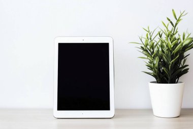 Minimalist Tablet and Stylus on Clean White Desk - Perfect for Graphic Designers clipart