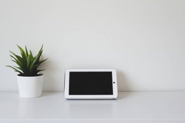 Minimalist Tablet and Stylus on Clean White Desk - Perfect for Graphic Designers