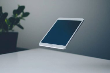 Minimalist Tablet and Stylus on Clean White Desk - Perfect for Graphic Designers