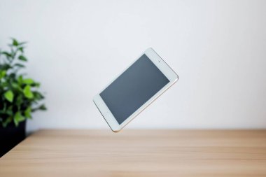 Minimalist Tablet and Stylus on Clean White Desk - Perfect for Graphic Designers