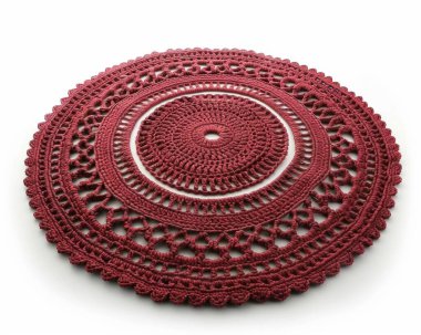 Intricate red crochet placemat showcasing detailed patterns and textures. clipart