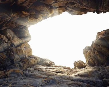 A dramatic rock formation framed by the entrance of a cave, illuminated by bright sunlight. clipart