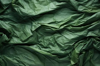 Textured green crumpled fabric background, adding depth and dimension to creative projects. clipart