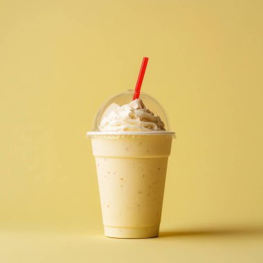 glass of tasty milkshake on color background