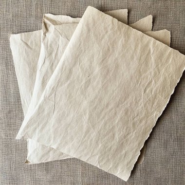 blank paper sheets on a brown background.