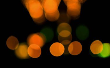 Colorful bokeh lights in warm tones creating a vibrant atmosphere. clipart