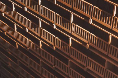 Geometric pattern of balconies casting shadows on a building facade. clipart