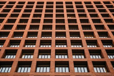 Modern brick building showcasing a grid of windows. clipart