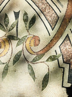 Intricate mosaic design featuring leaves and spirals in soft earthy tones. clipart