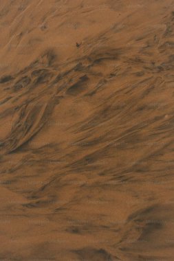 A serene abstract of swirling brown tones resembling flowing sand. clipart