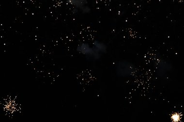 Sparkling fireworks illuminate the night sky in a vibrant display. clipart