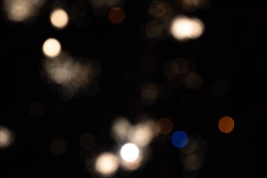 Abstract light patterns with blurred bokeh effects in dark setting. clipart