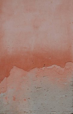 Textured wall with a gradient of peach and beige tones. clipart