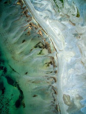 Aerial view of a stunning coastal landscape with vibrant turquoise waters and sandy shores. clipart