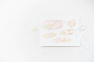 Delicate watercolor art with soft hues and a ribbon accent on a white background. clipart