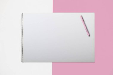 A blank sketchbook with a pink pen on a pastel pink and white background. clipart