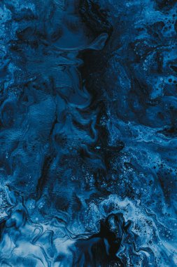 Abstract dark blue texture with dynamic fluid patterns and bubbles. clipart