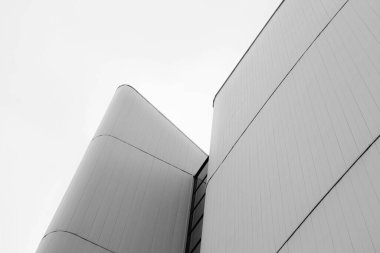 Abstract view of a sleek, modern architectural structure in monochrome tones. clipart