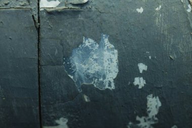 Close-up of chipped blue paint revealing a textured background. clipart