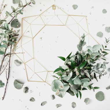 Stylish geometric wreath adorned with fresh greenery and eucalyptus leaves. clipart