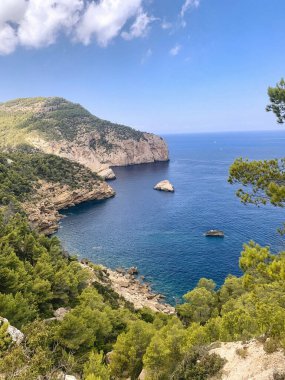 Breathtaking coastal view of blue waters and rocky cliffs in a serene setting. clipart