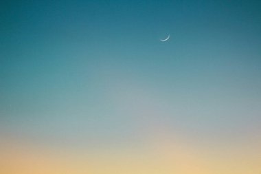 A serene twilight sky with a crescent moon glowing softly. clipart