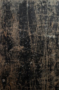 Close-up of weathered black wooden surface with scratches and stains. clipart