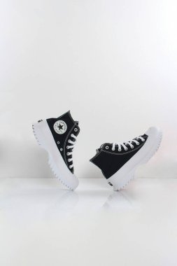 Stylish black and white high-top sneakers with unique sole design. clipart