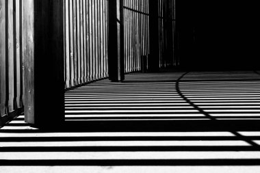 Intricate shadows cast by wooden structures in black and white. clipart