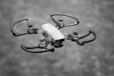 A sleek drone in mid-flight captured in a striking monochrome setting. clipart