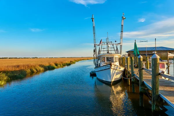 stock image Sunset with shrimp boat along a dock at Tybee Island, Ga.