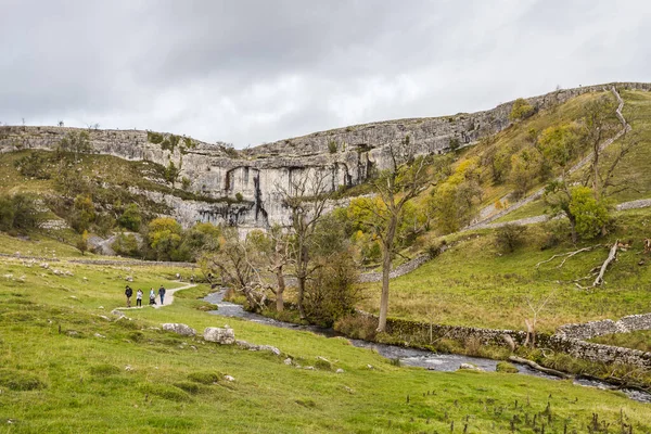 Incidental people seen walking along a pathway to Malham Cove in the Yorkshire Dales seen in October 2022.