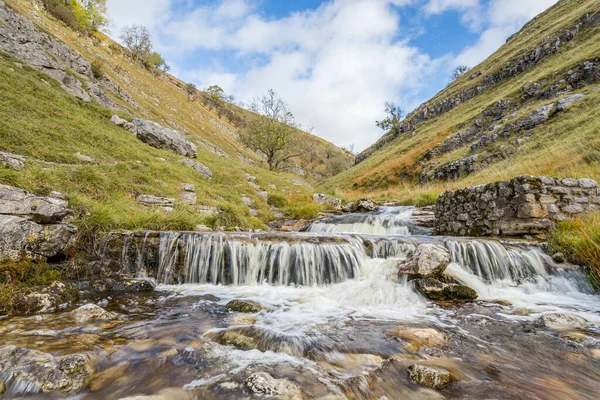 stock image Water flowing over the cascades and small waterfalls along Bucken Beck in the Upper Wharfedale area of Yorkshire.