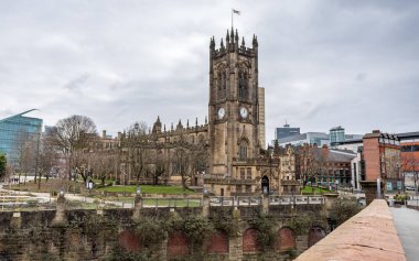 Manchester Cathedral seen from Cathedral Approach over the Irwell River in February 2023.