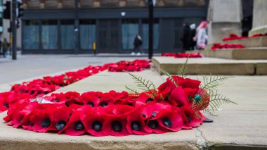 Close up poppy wreaths left around the Cenotaph in Manchester city centre.