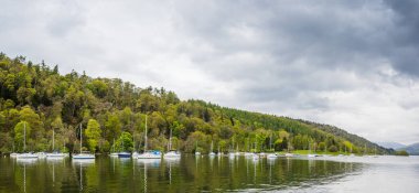 Windermere Gölü 'ndeki Mitchell Wyke Ferry Körfezi' nde demirlemiş yelkenli tekne ve yatlardan oluşan çok görüntülü bir panorama. Lake District Ulusal Parkı 'nın en büyük gölü..