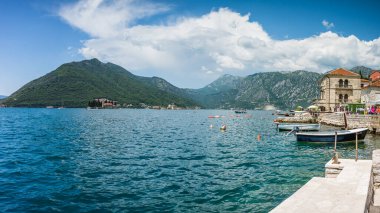 Perast rıhtımının önündeki çok görüntülü tekne manzarası. St. George Adası olarak bilinen bu iki ada Mayıs 2023 'te görüldü..
