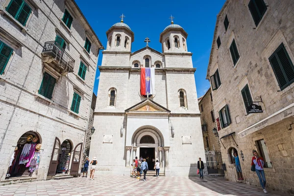 stock image Tourists pictured mingling around the courtyard in front of the Church of St Nicholas in Kotor, Montenegro in June 2023.