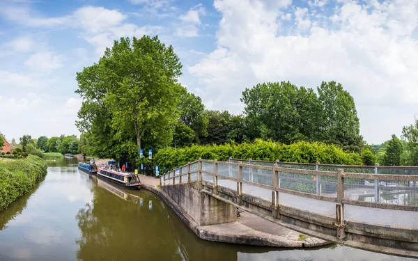 stock image A multi image panorama captured from a footbridge at Anderton overlooking narrow boats on the Trent and Mersey canal in June 2023.