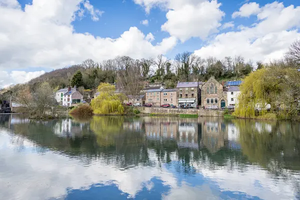 stock image Cromford Mill Pond pictured on a bright spring day in March 2024 surrounded by willow trees and old houses.