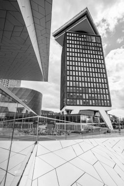 A black and white image full of modern architecture as the Eye Film Museum frames part of the the A'Dam Tower in Amsterdam, the Netherlands on 27 May 2024. clipart