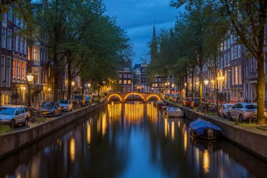 Alacakaranlık, Leidsegracht kanalı boyunca Hollanda, Amsterdam 'da Herengracht ile buluştuğu köprüye doğru ilerliyor..