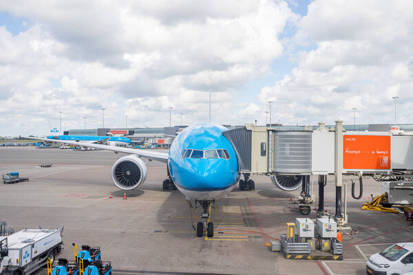 A KLM aircraft pictured in a gate at Amsterdam Schiphol Airport, the Netherlands after arriving on 29 May 2024.