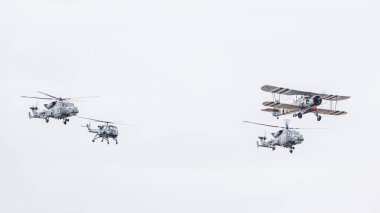 Taranto formation above Southport comrpising Westland Wasp, Royal Navy Swordfish and a pair of Wildcat HMA2 helicopters pictured on 13 July 2024 in Merseyside, England. clipart