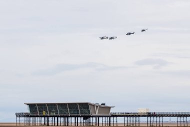 Taranto formation above Southport Pier comrpising Westland Wasp, Royal Navy Swordfish and a pair of Wildcat HMA2 helicopters pictured on 13 July 2024 in Merseyside, England. clipart