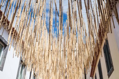 Dozens of bamboo canes hanging above a street in Camara de Lobos, Madeira pictured on 8 August 2024 as part of the festival of Arts, Creativity and Sustainability. clipart