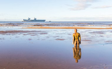 HMS Prince of Wales pictured from Crosby beach near Liverpool approaching the River Mersey on 1 December 2024 as it visits Liverpool for the second time. clipart